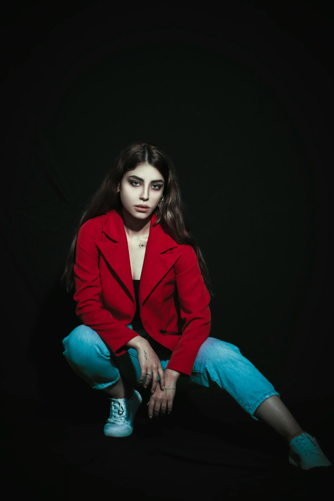 Studio portrait of a woman in a red blazer