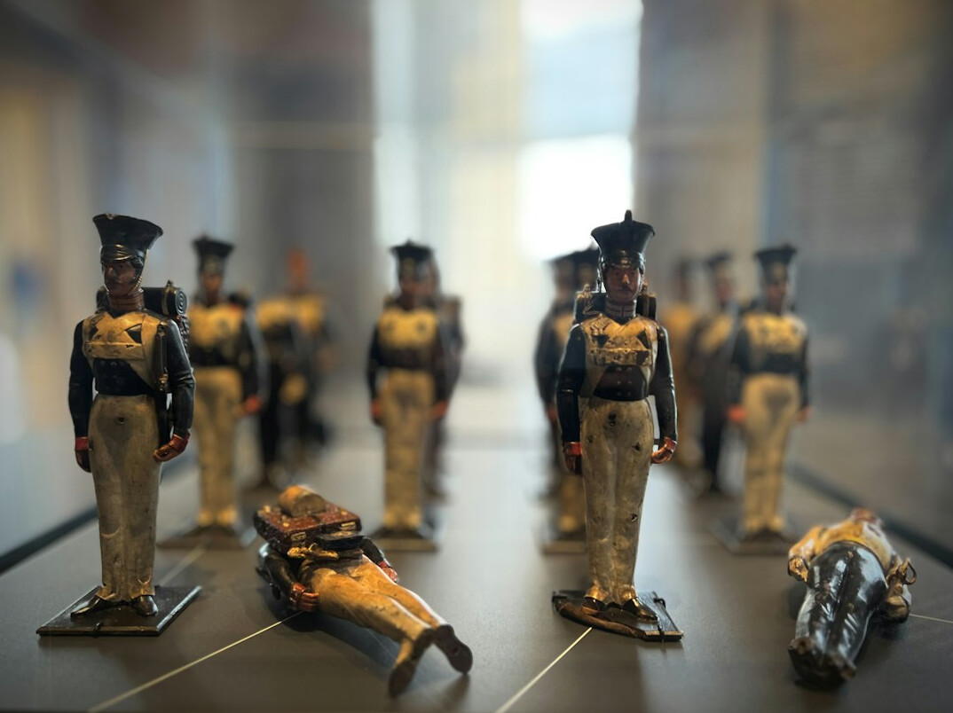 Collection of small historical figurines inside a museum display case