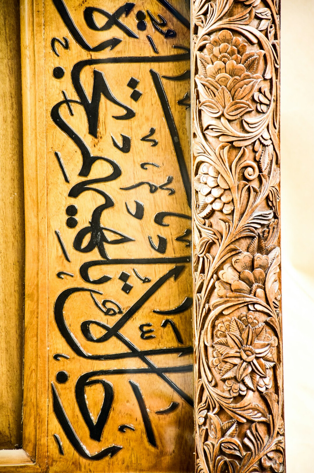 Close-up of an ornate illuminated manuscript with gold calligraphy
