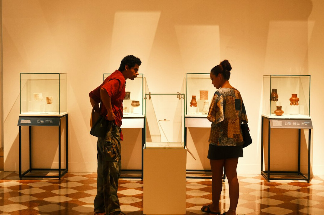 Illuminated museum display cases in a dim exhibition hall