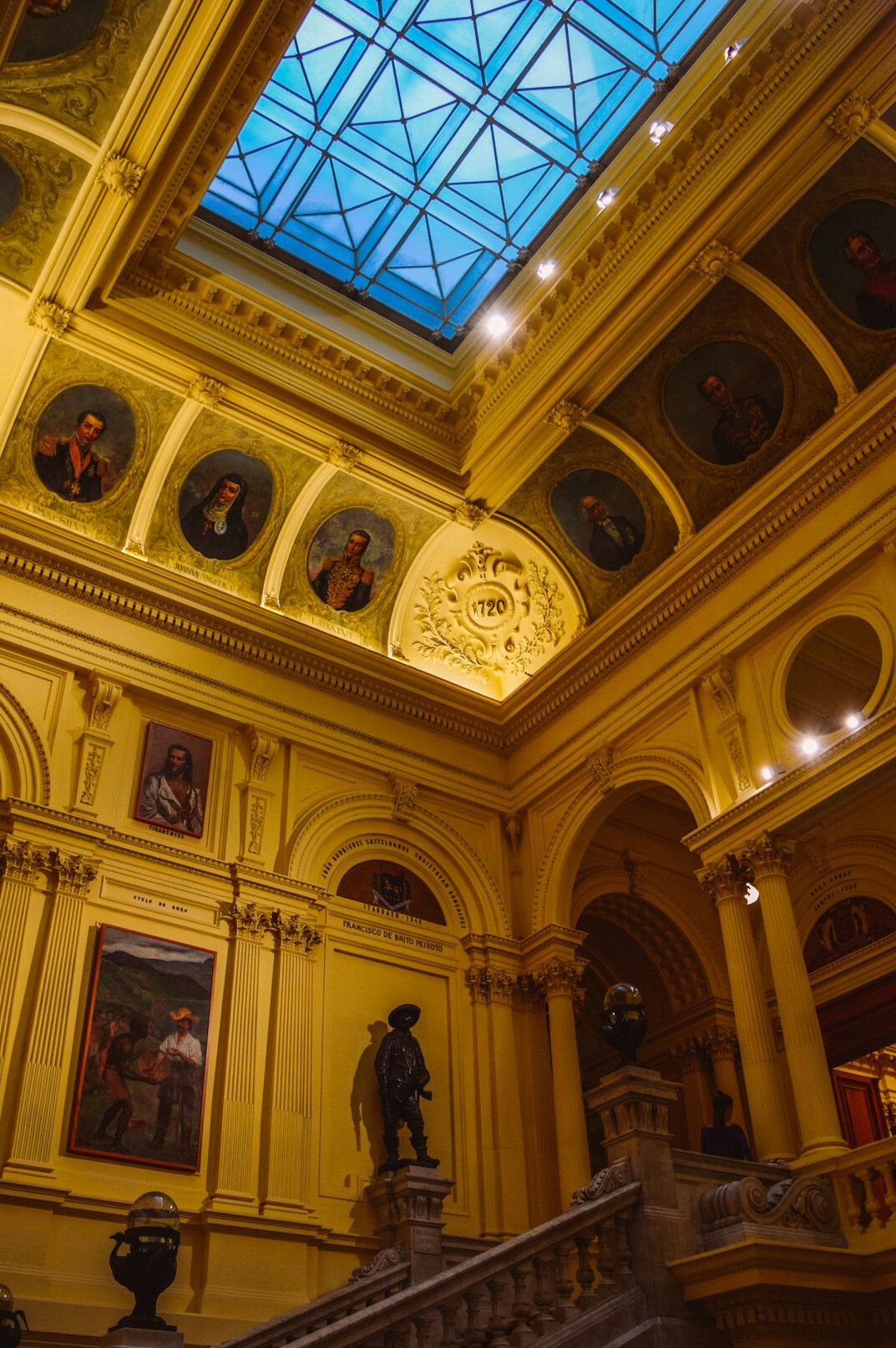 Grand museum hall with statues and skylight